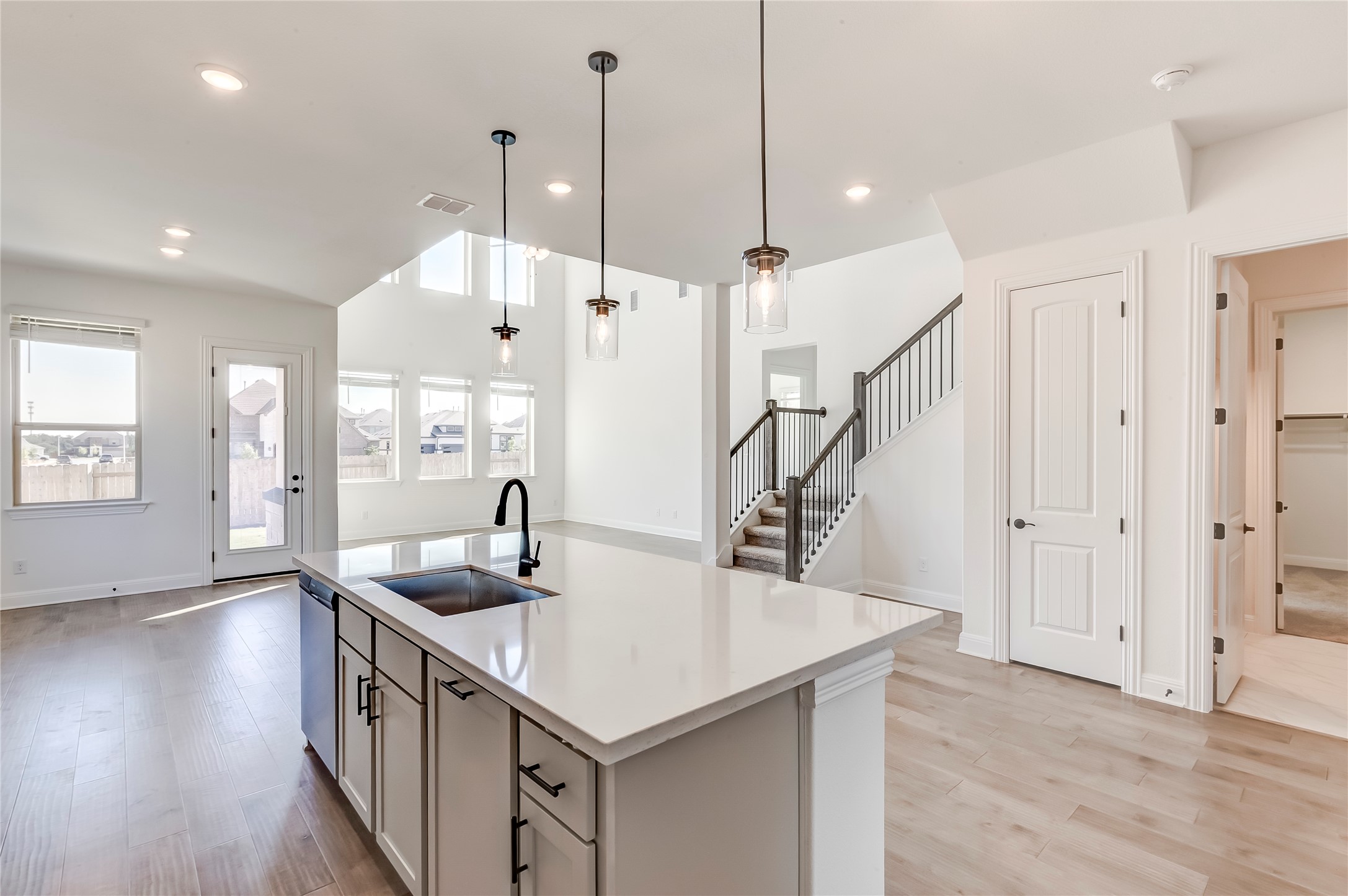 920 Old Gdn Road Leander, TX 78641 - Photo 39 of 39 Kitchen featuring open floor plan, a center island with sink, light wood-style flooring, pendant lighting, and recessed lighting