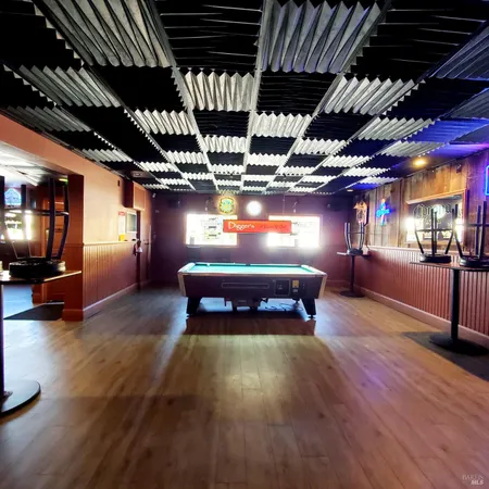 a room with pool table windows and outdoor view