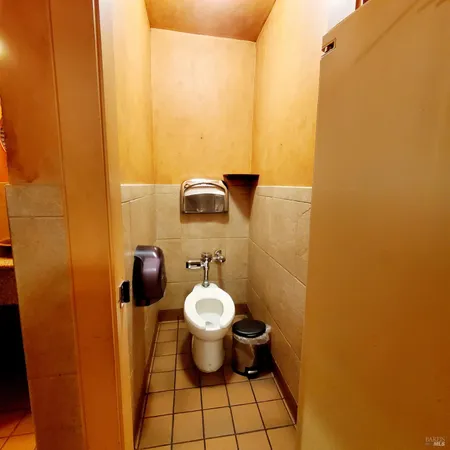 a white toilet sitting next to a bathroom sink