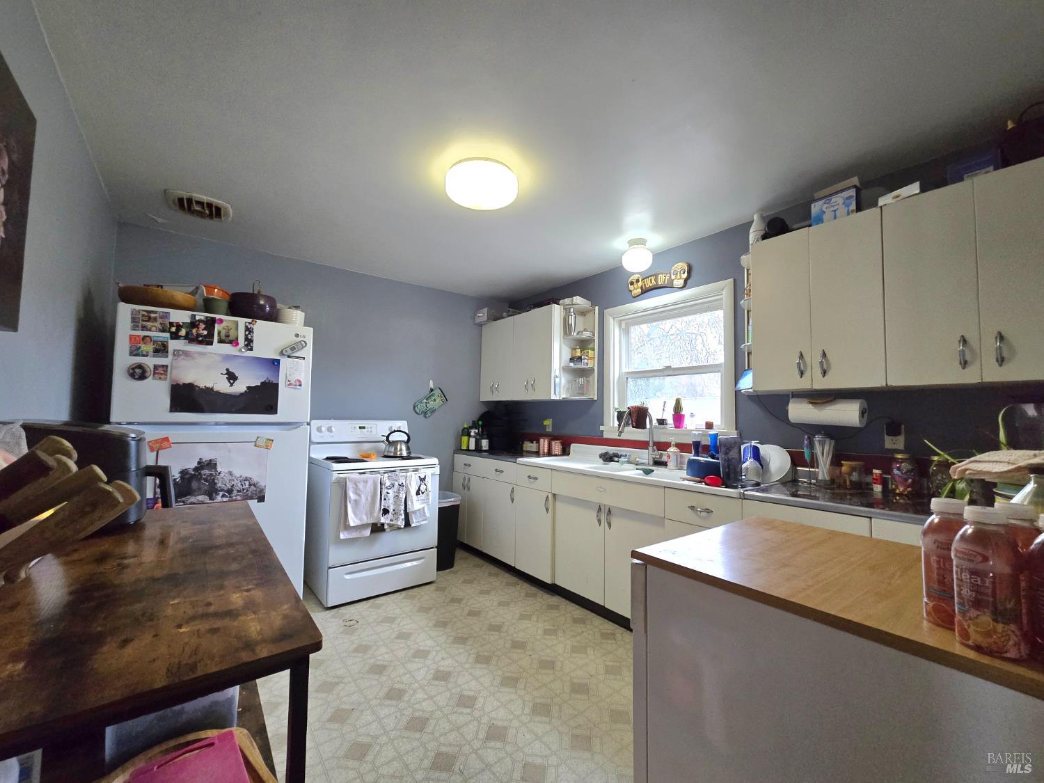 244 South Main Street Willits, CA 95490 - Photo 31 of 48 a kitchen that has a lot of cabinets a sink and appliances in it