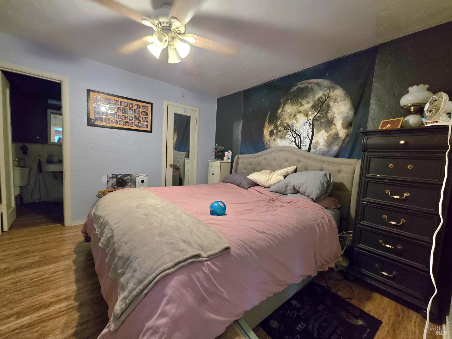 244 South Main Street Willits, CA 95490 - Photo 33 of 48 a bedroom with a bed and a chandelier