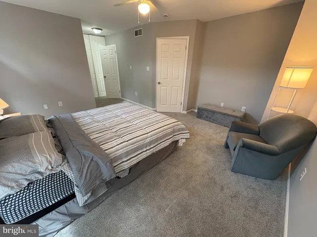 a bedroom with bed and window