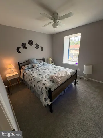 a bed sitting in a bedroom next to a window