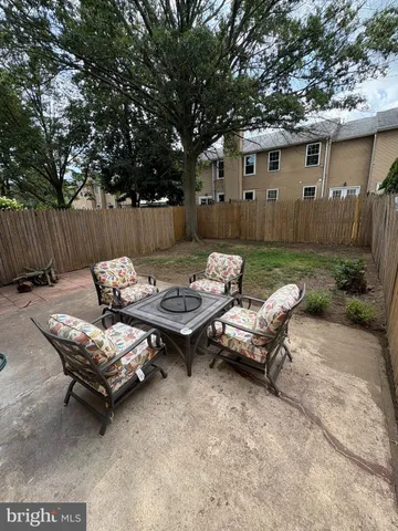 a backyard of a house with table and chairs