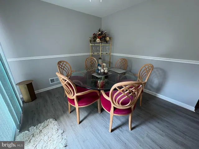 a dining room with furniture and wooden floor