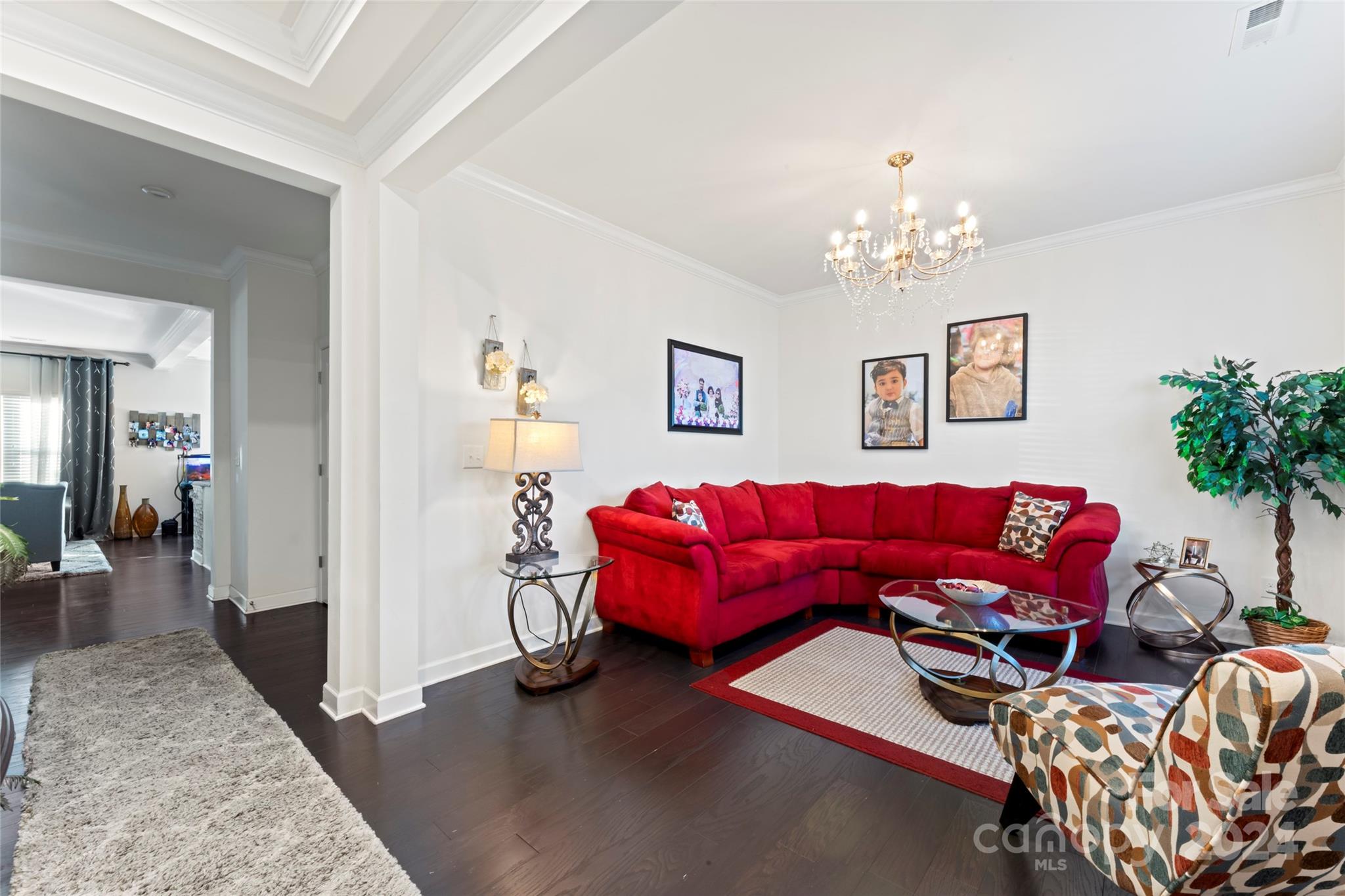 7227 Rupell Drive Charlotte, NC 28273 - Photo 20 of 45 a living room with furniture and a chandelier