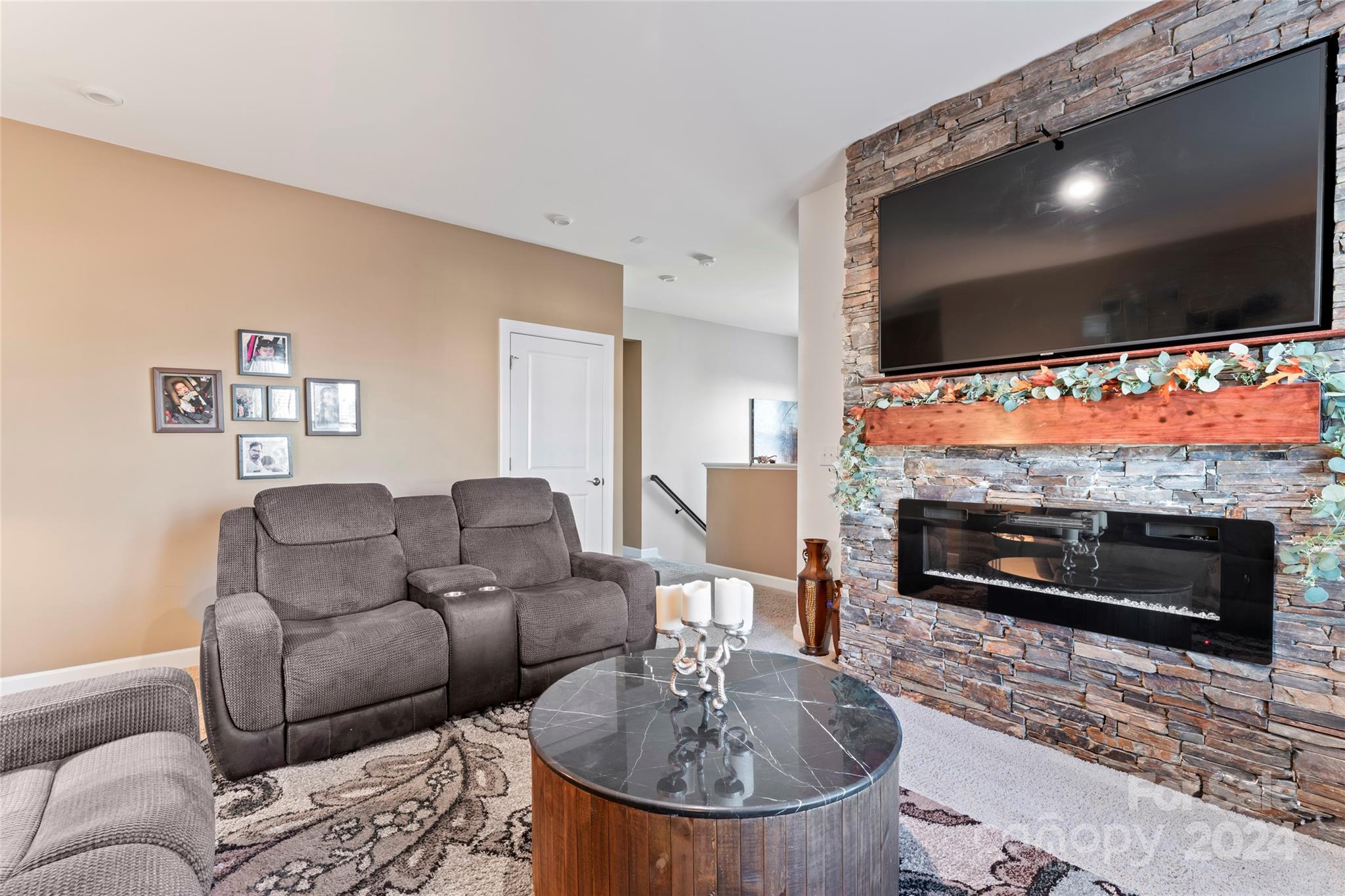 7227 Rupell Drive Charlotte, NC 28273 - Photo 22 of 45 a living room with furniture a flat screen tv and a fireplace