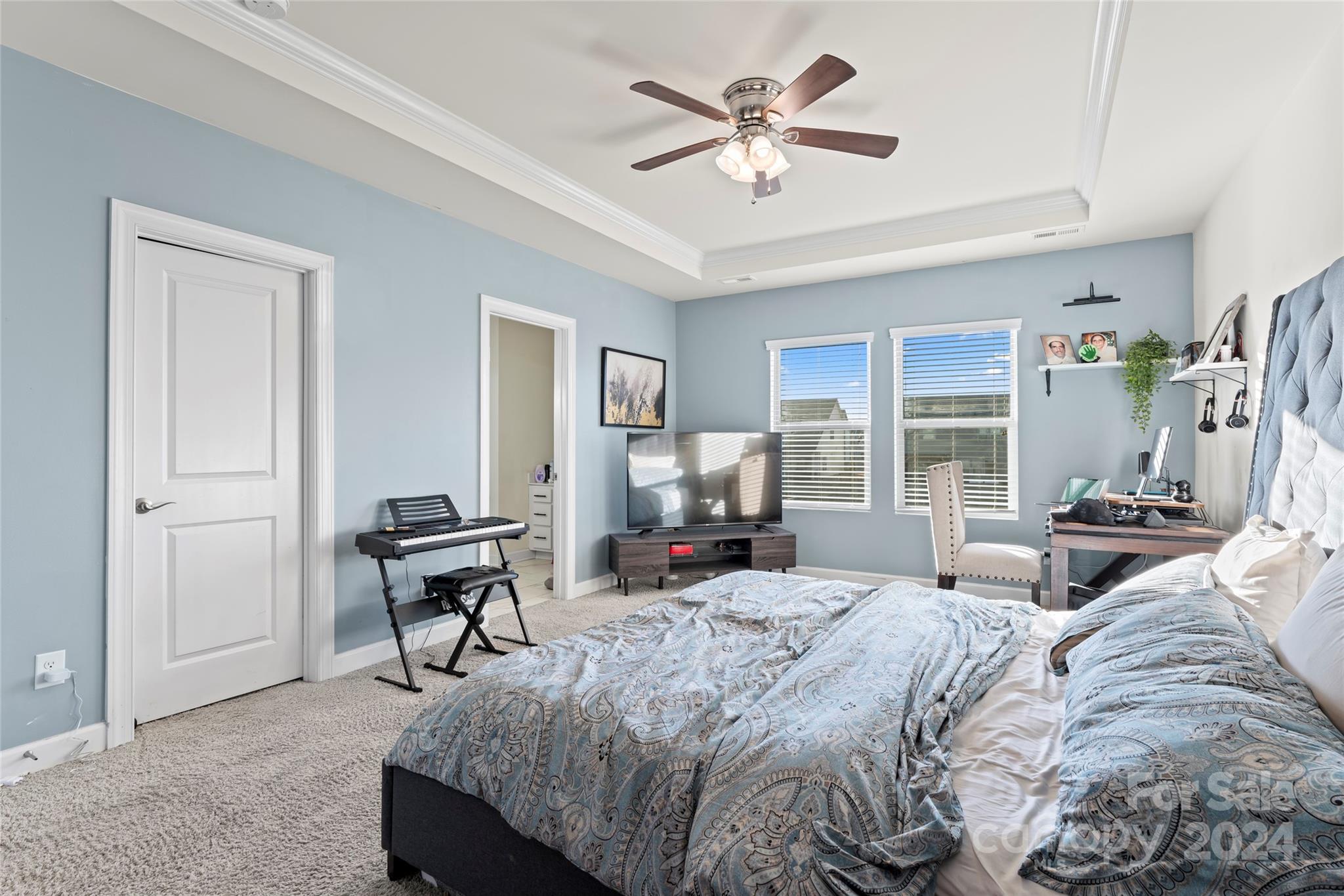 7227 Rupell Drive Charlotte, NC 28273 - Photo 25 of 45 a bedroom with a bed and a chandelier