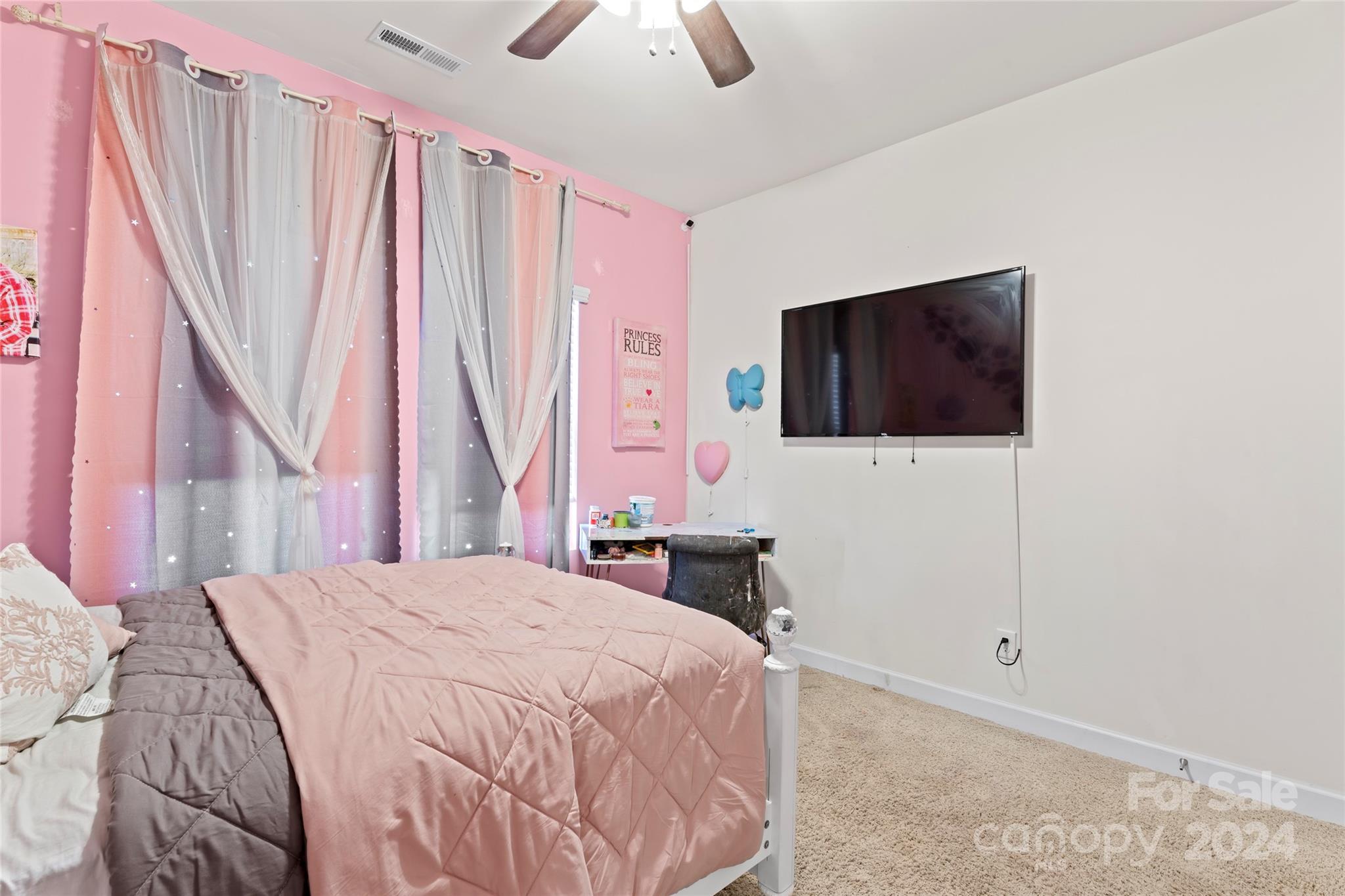 7227 Rupell Drive Charlotte, NC 28273 - Photo 28 of 45 a bedroom with a bed a flat screen tv and a book shelf