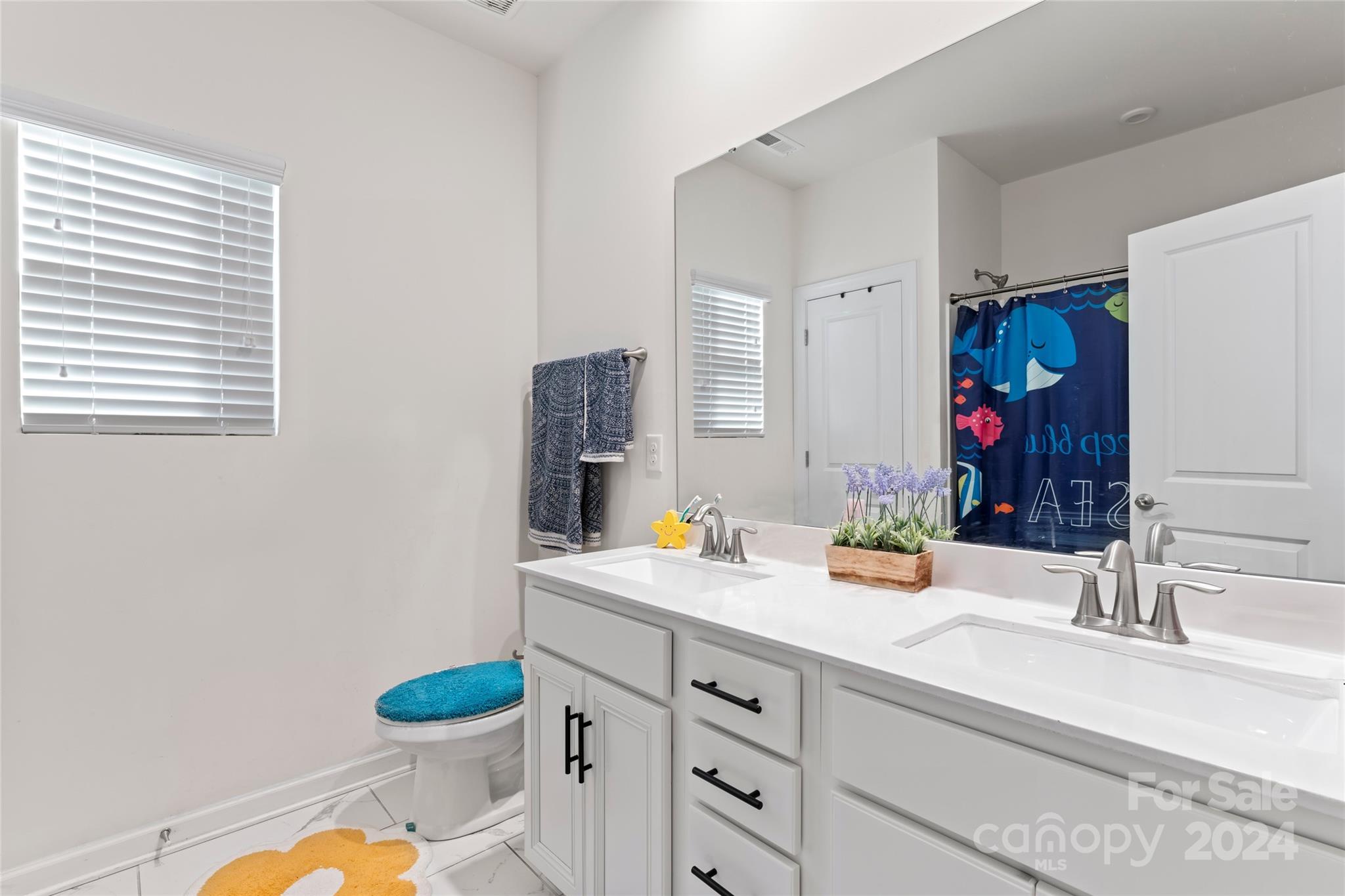 7227 Rupell Drive Charlotte, NC 28273 - Photo 35 of 45 a bathroom with a granite countertop sink mirror vanity and toilet