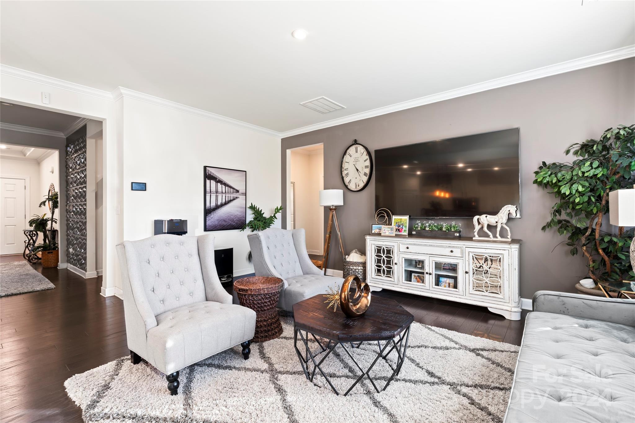 7227 Rupell Drive Charlotte, NC 28273 - Photo 5 of 45 a living room with furniture a flat screen tv and a clock