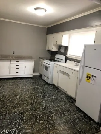 a kitchen with a refrigerator and a stove