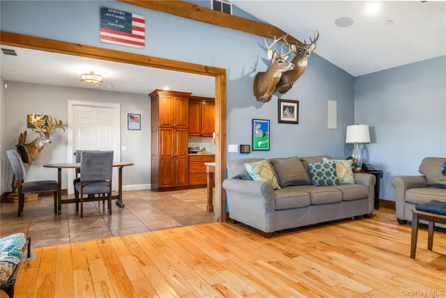 a living room with furniture and wooden floor