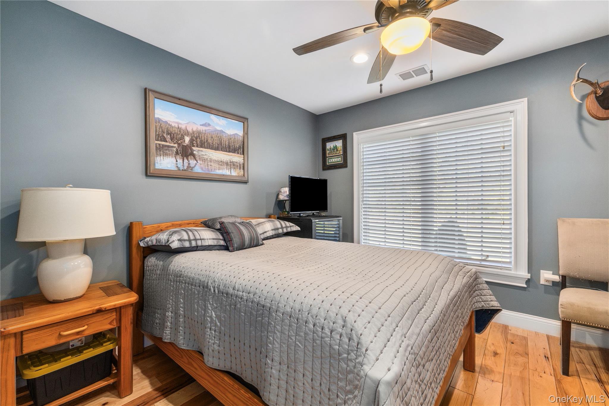 80 Rudd Pond Road Millerton, NY 12546 - Photo 17 of 22 a bedroom with a bed and a flat screen tv