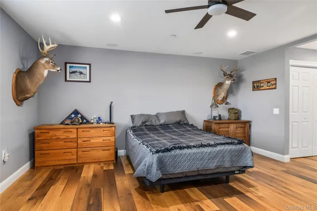 a bedroom with a bed and ceiling fan