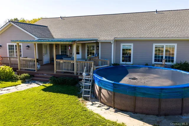 a view of a house with backyard porch and sitting area