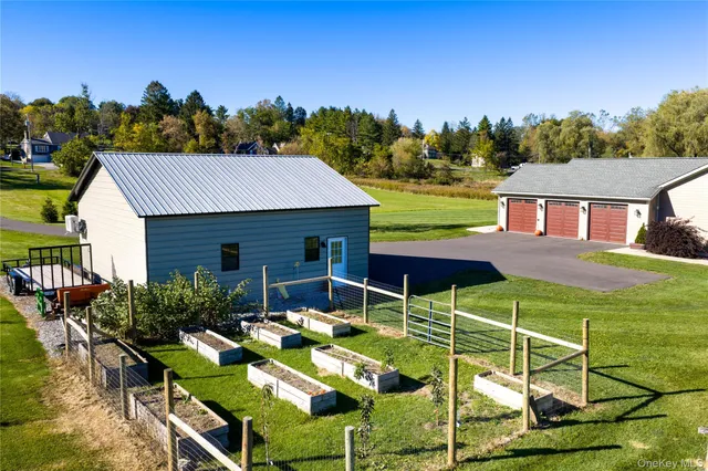 a view of a patio with table and chairs under an umbrella