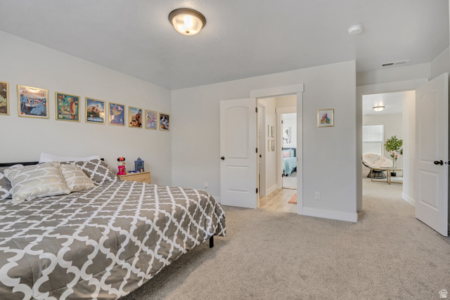 1577 Quailhill Road Saratoga Springs, UT 84045 - Photo 28 of 46 Bedroom featuring light carpet and baseboards