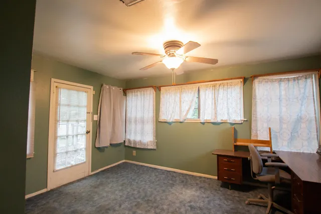a view of a house with backyard and trees