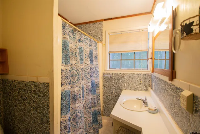 a view of an empty room with window and fire place