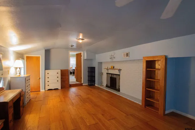 a backyard of a house with table and chairs