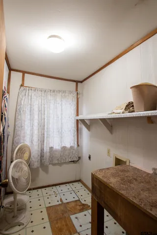 a view of a park with furniture and a yard