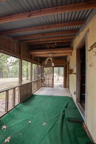 a view of dirt field with trees in the background