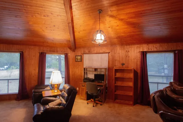 a view of a livingroom with furniture and windows