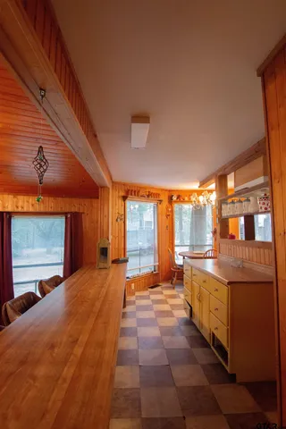 a large bedroom with a large bed and large windows