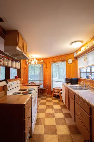 a kitchen with stainless steel appliances a stove a sink and a microwave
