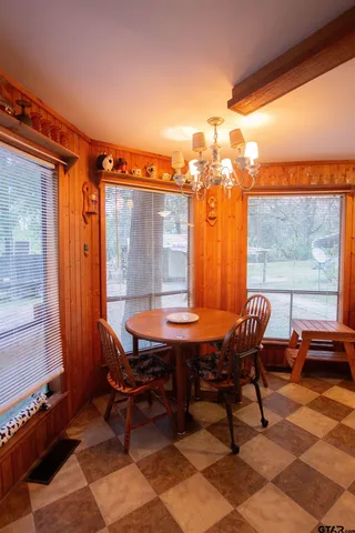 a view of a dining room with furniture and window
