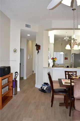 a view of a dining room with furniture and a chandelier