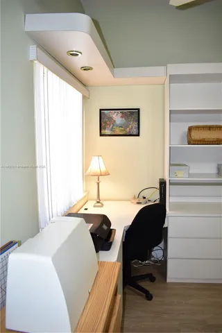 a bedroom with a bed and a desk