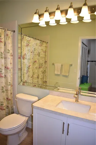 a bathroom with a sink a toilet and bathtub