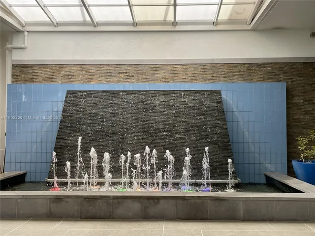 a living room with fireplace furniture and a large window