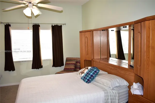 a bedroom with a large bed and a large window