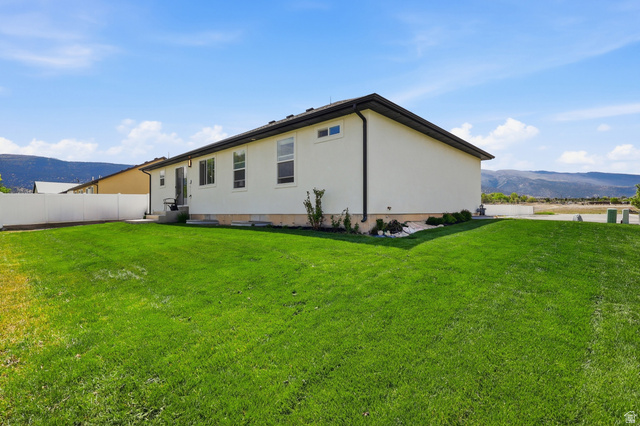 625 East 100 South Ephraim, UT 84627 - Photo 26 of 26 Expansive green lawn surrounds a contemporary single-story residence with a light-colored stucco exterior