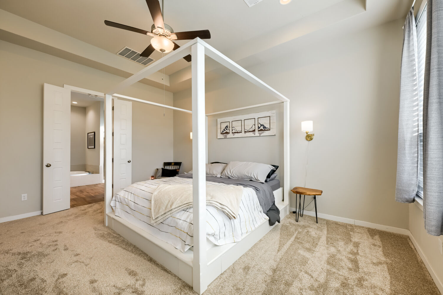 621 Rancho Sienna Loop Georgetown, TX 78628 - Photo 14 of 28 A cozy bedroom with plush carpeting leads to a private ensuite bathroom, offering comfort and convenience.