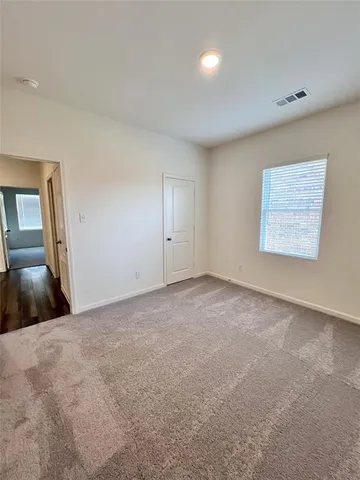 a view of a hallway with wooden floor and entryway