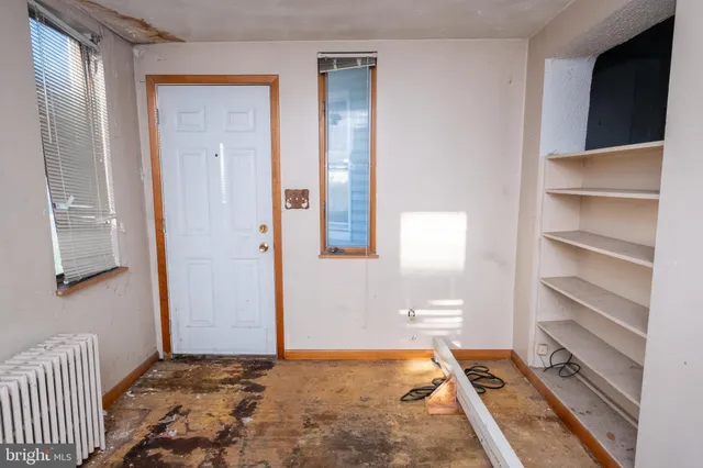a view of a room with gym equipment and a window