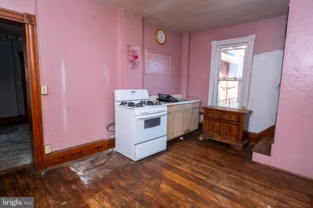 a living room with furniture and a hallway