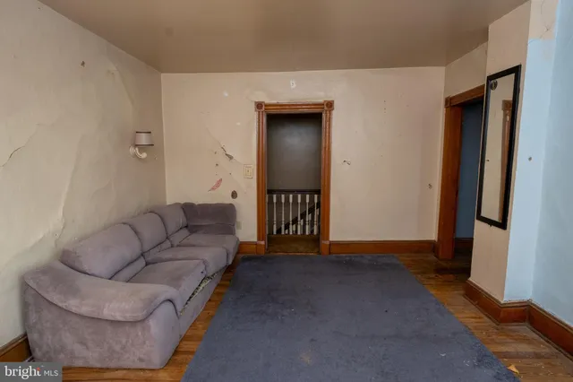 a view of a livingroom with a couch and windows