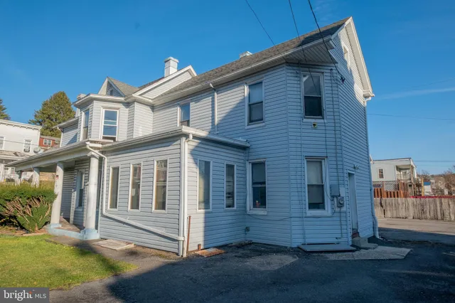 a view of a house with wooden fence