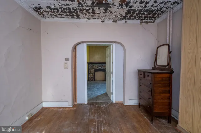 a view of an empty room with a fireplace and a window