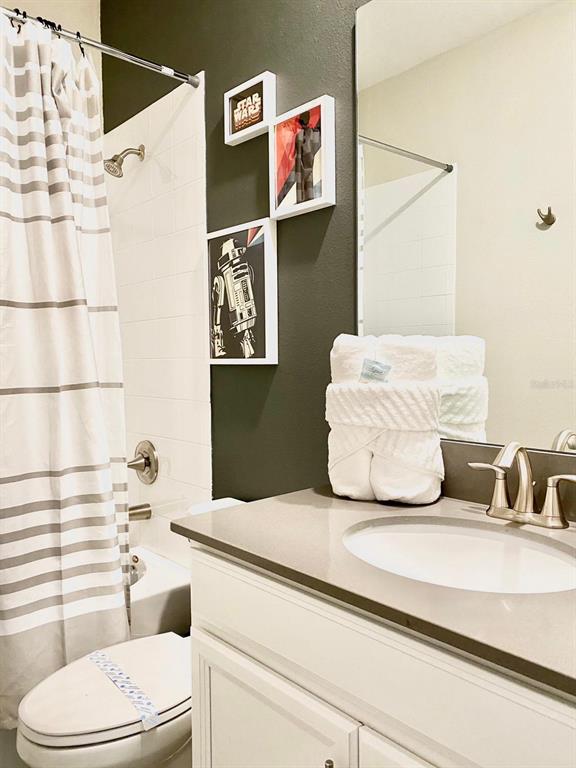 8983 Backswing Way Davenport, FL 33896 - Photo 15 of 30 a bathroom with a toilet sink and mirror