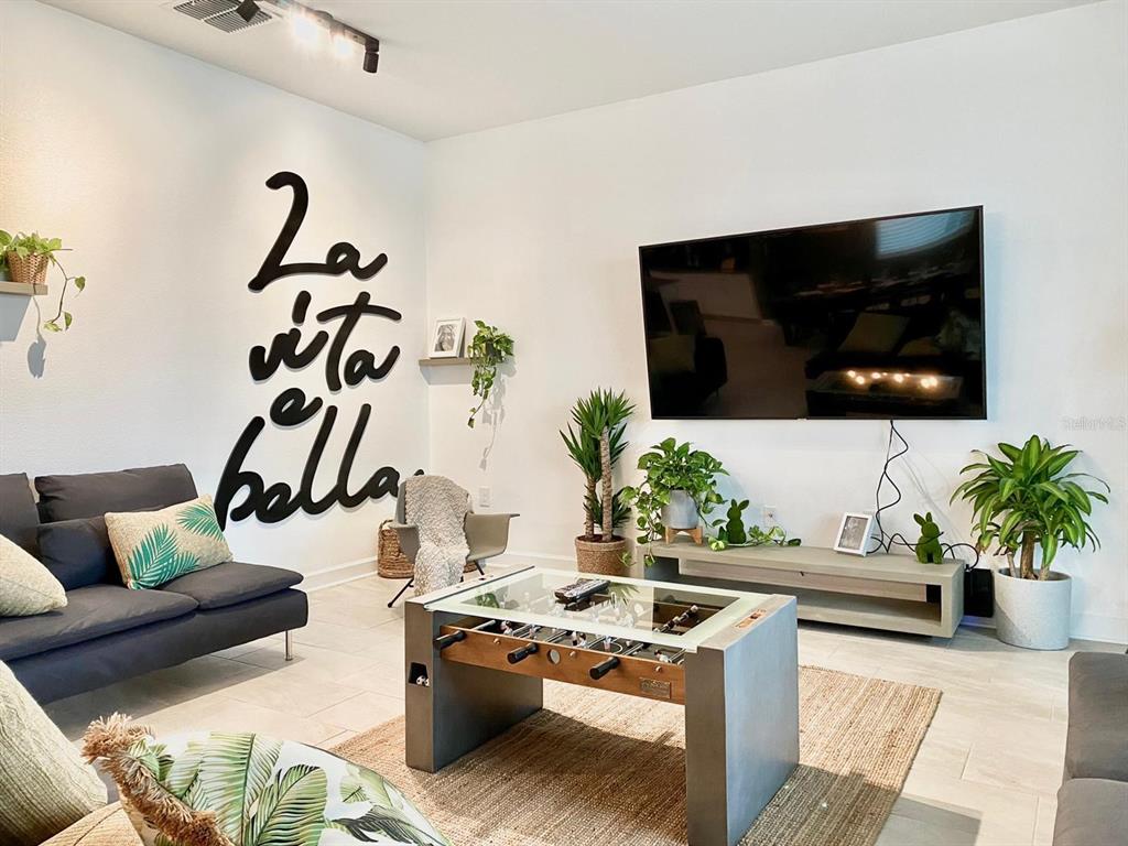 8983 Backswing Way Davenport, FL 33896 - Photo 4 of 30 a living room with furniture and a flat screen tv