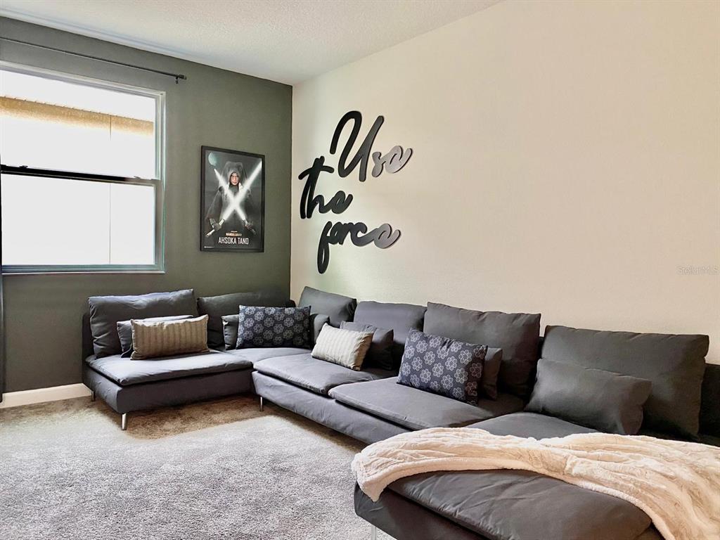 8983 Backswing Way Davenport, FL 33896 - Photo 7 of 30 a living room with furniture and a window