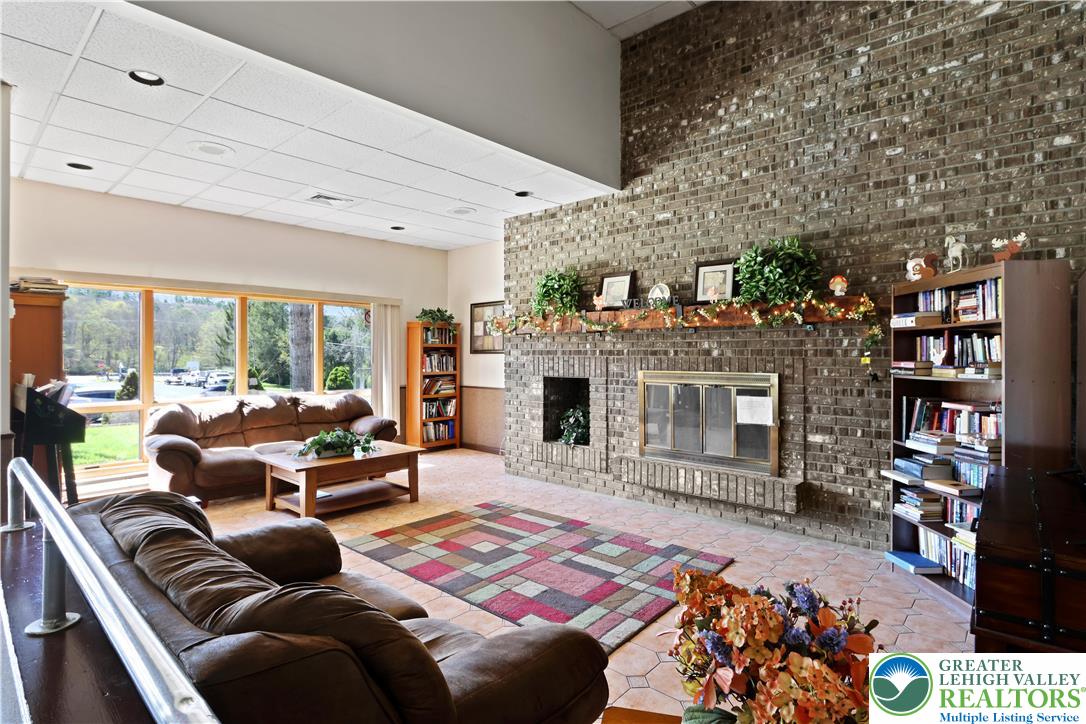 214 Mockingbird Court Bushkill, PA 18324 - Photo 31 of 40 a living room with furniture a rug and a fireplace