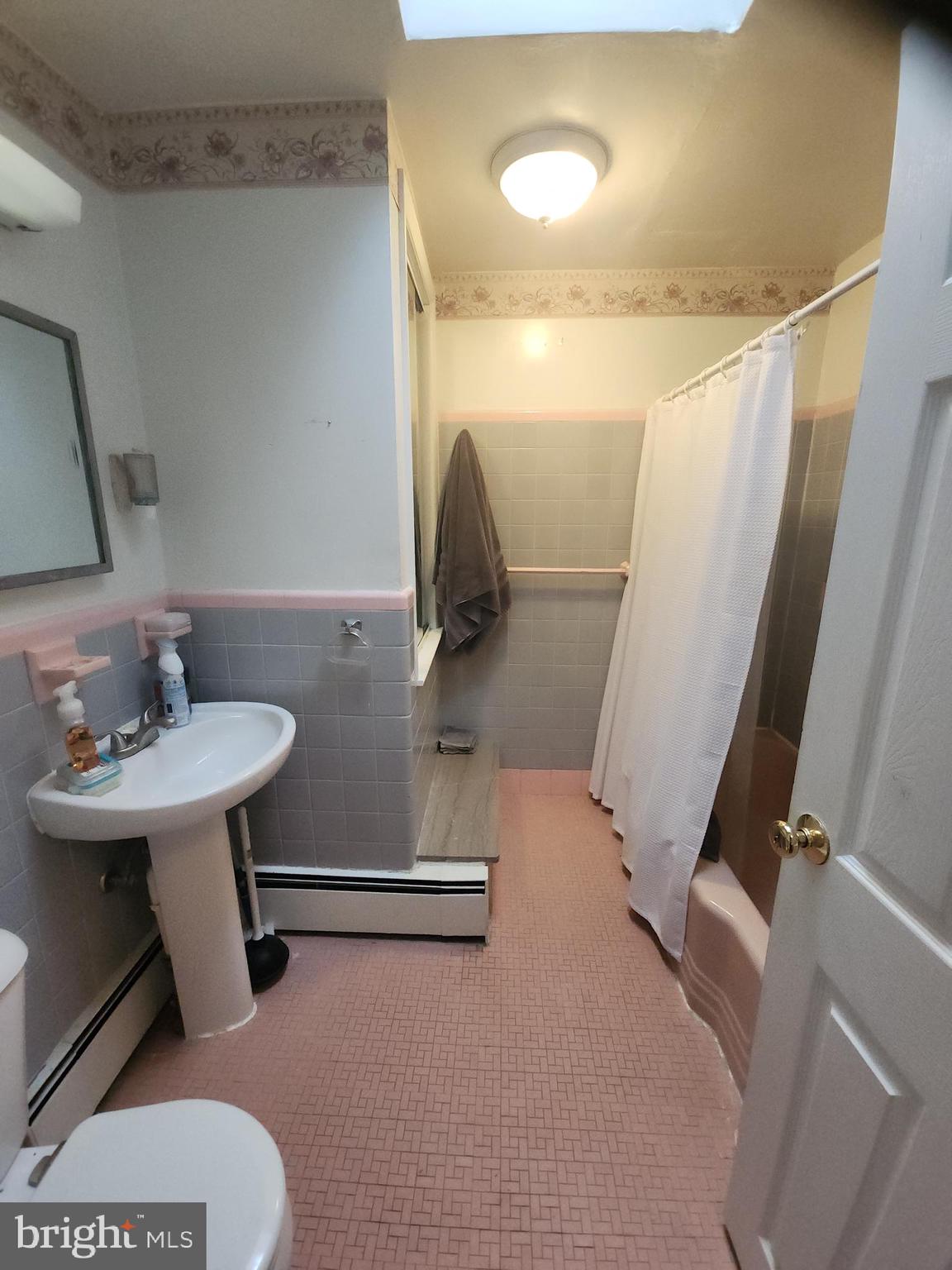 8409 Loretto Avenue Philadelphia, PA 19152 - Photo 13 of 22 a bathroom with a sink toilet and a mirror