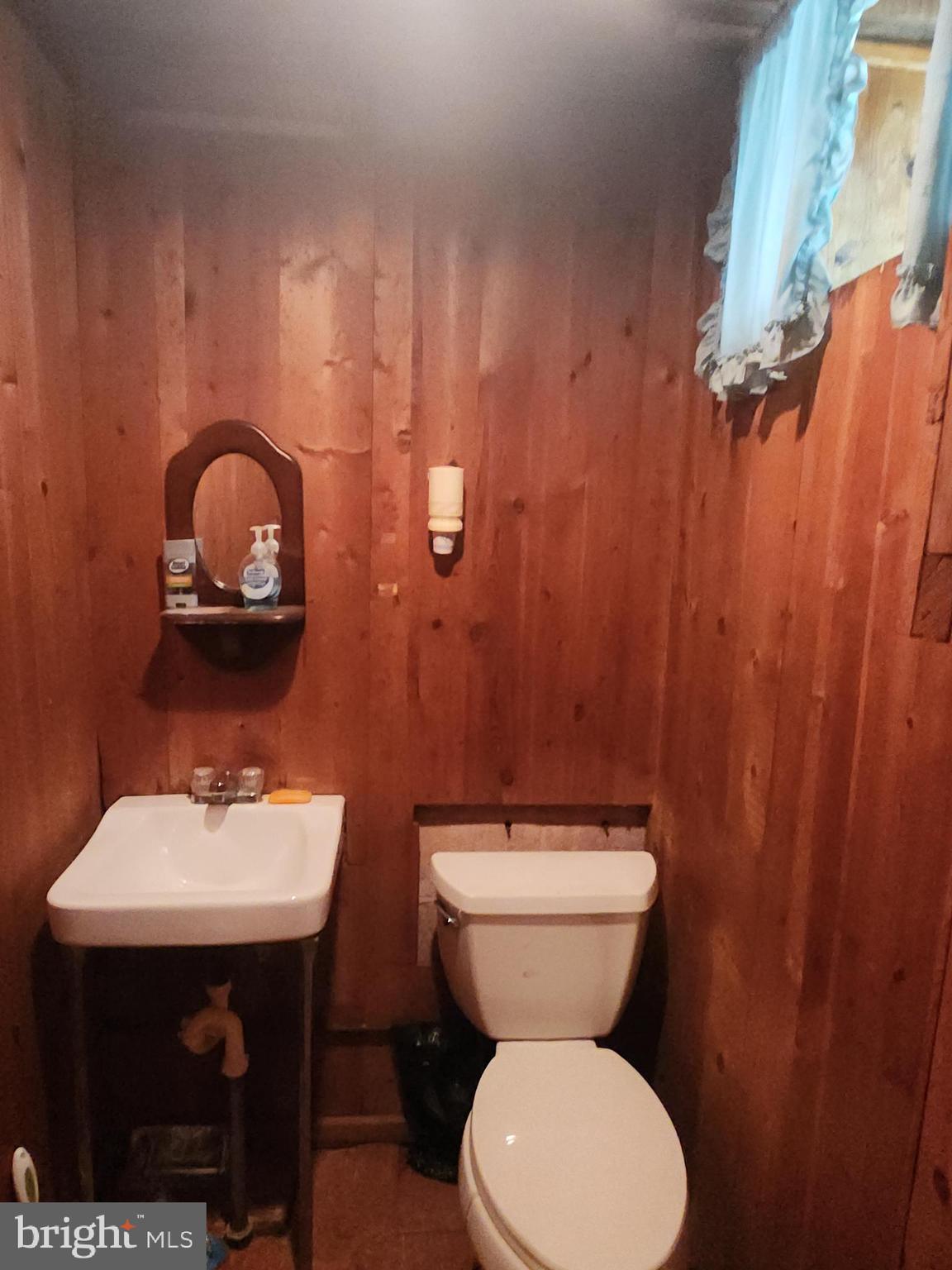 8409 Loretto Avenue Philadelphia, PA 19152 - Photo 17 of 22 a bathroom with a toilet sink and mirror